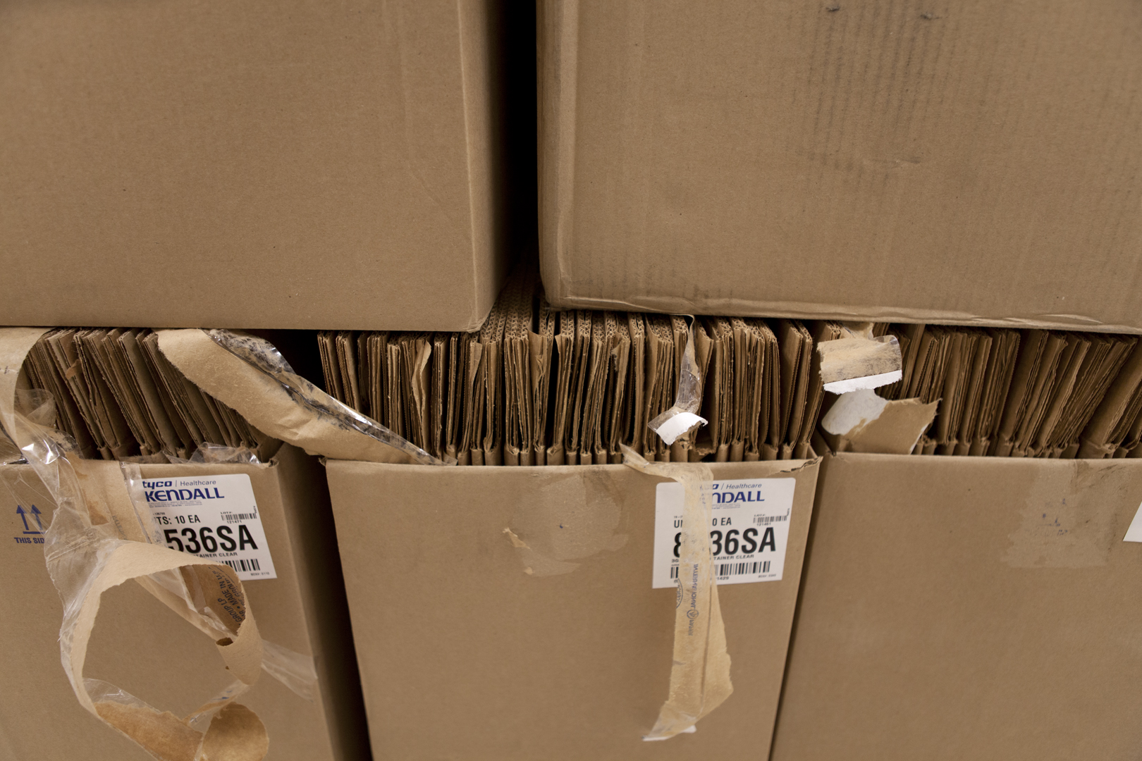 Close uo shot of broken down boxes stacked inside of a cardboard box.